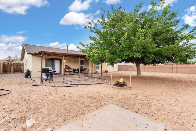 6404 Gambel Quail Rd NE, Rio Rancho, NM 87144 - back of house featuring a fire pit, stucco siding, a patio, and a fenced backyard