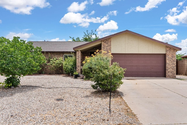 6404 Gambel Quail Rd NE, Rio Rancho, NM 87144 - view of front of home featuring a garage, driveway, and brick siding