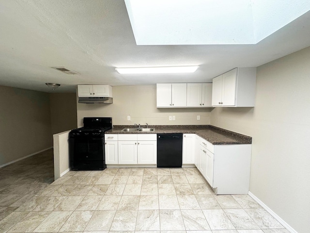 213 Green Valley Rd NW, Los Ranchos, NM 87107 - kitchen featuring black appliances, under cabinet range hood, white cabinets, and a skylight