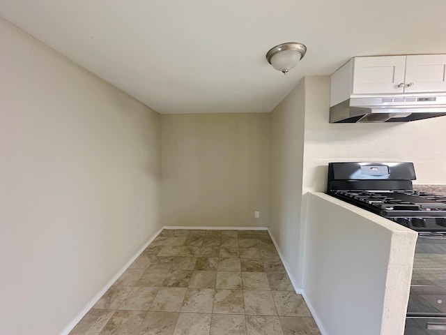 213 Green Valley Rd NW, Los Ranchos, NM 87107 - kitchen with under cabinet range hood, black range with gas cooktop, white cabinetry, and light stone finish floors