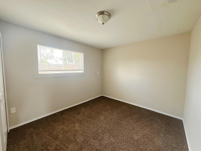 213 Green Valley Rd NW, Los Ranchos, NM 87107 - empty room featuring dark colored carpet and baseboards