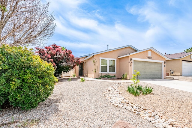 3742 Cattle Dr NE, Rio Rancho, NM 87144 - ranch-style home with stucco siding, an attached garage, and driveway