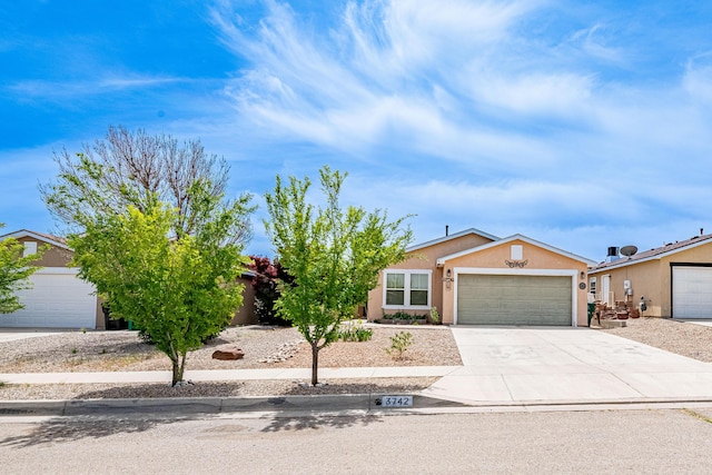3742 Cattle Dr NE, Rio Rancho, NM 87144 - view of front facade featuring stucco siding, an attached garage, and concrete driveway