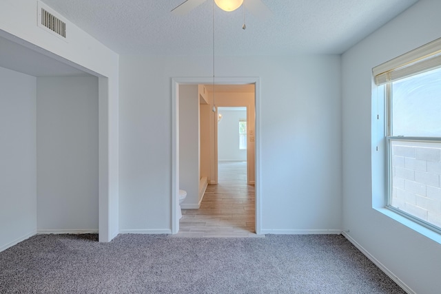 3742 Cattle Dr NE, Rio Rancho, NM 87144 - unfurnished room featuring carpet, a textured ceiling, and a ceiling fan