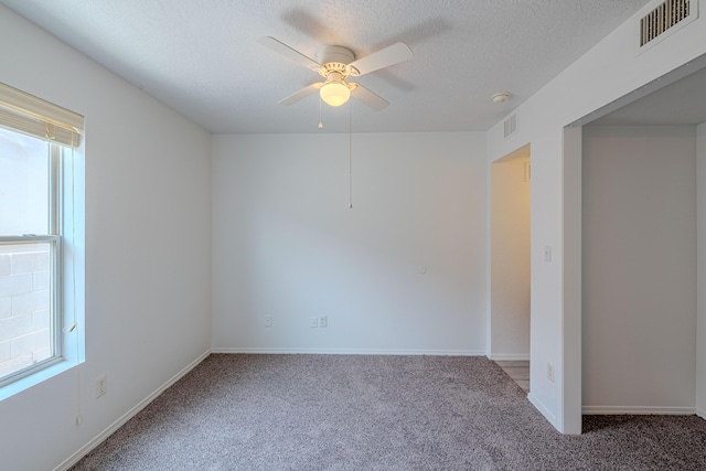 3742 Cattle Dr NE, Rio Rancho, NM 87144 - carpeted empty room with healthy amount of natural light, a ceiling fan, and a textured ceiling