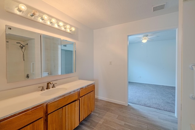 3742 Cattle Dr NE, Rio Rancho, NM 87144 - full bathroom with a ceiling fan, vanity, wood finished floors, a textured ceiling, and a shower