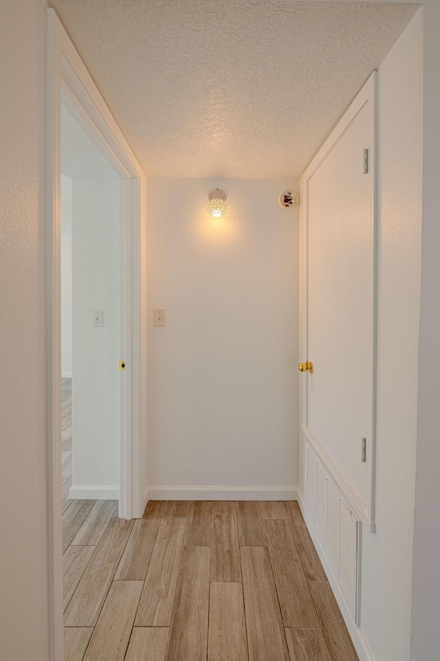 3742 Cattle Dr NE, Rio Rancho, NM 87144 - corridor with light wood-type flooring and a textured ceiling