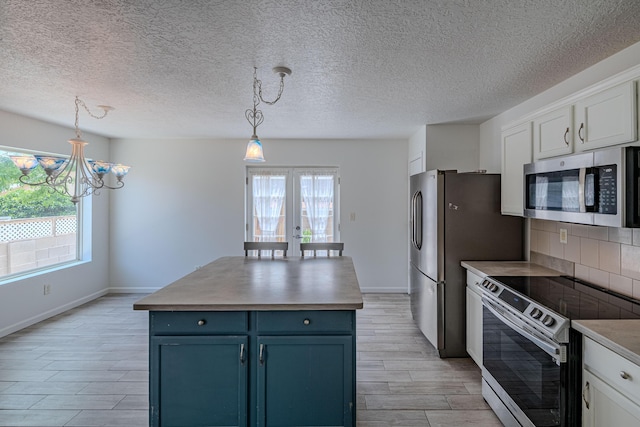 3742 Cattle Dr NE, Rio Rancho, NM 87144 - kitchen with stainless steel appliances, blue cabinetry, plenty of natural light, french doors, and a textured ceiling