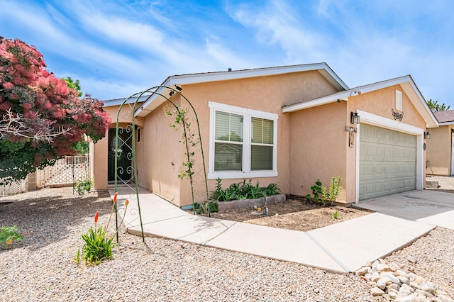 3742 Cattle Dr NE, Rio Rancho, NM 87144 - view of front of home with a garage, stucco siding, and driveway
