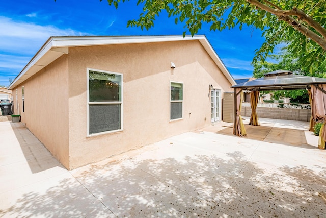 3742 Cattle Dr NE, Rio Rancho, NM 87144 - view of property exterior with stucco siding, a gazebo, and a patio