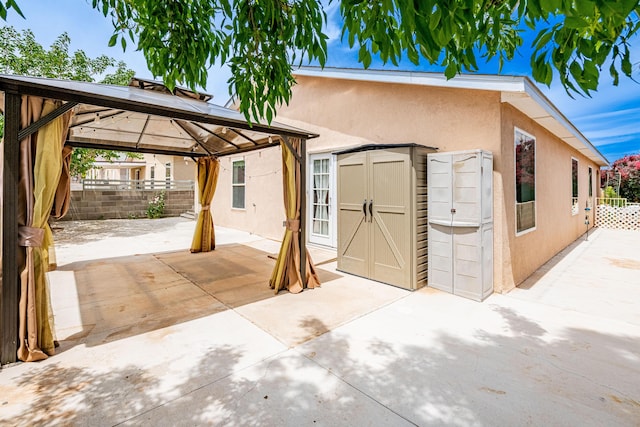 3742 Cattle Dr NE, Rio Rancho, NM 87144 - exterior space with a patio area, a shed, stucco siding, and a gazebo