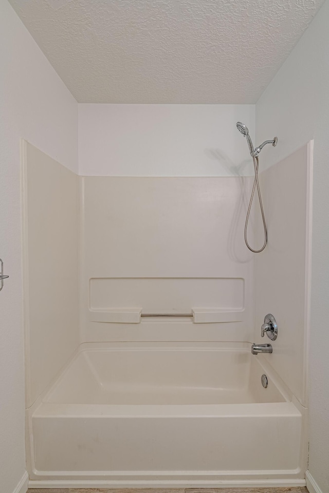 3742 Cattle Dr NE, Rio Rancho, NM 87144 - bathroom with shower / bath combination and a textured ceiling
