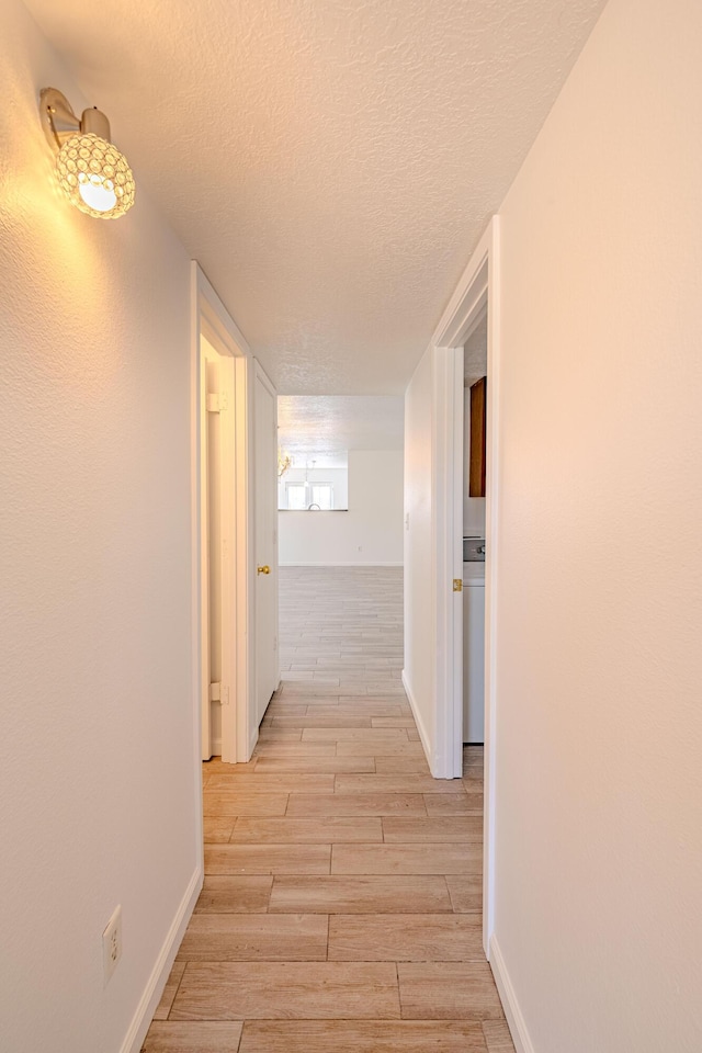3742 Cattle Dr NE, Rio Rancho, NM 87144 - corridor with a textured ceiling and light wood-style floors