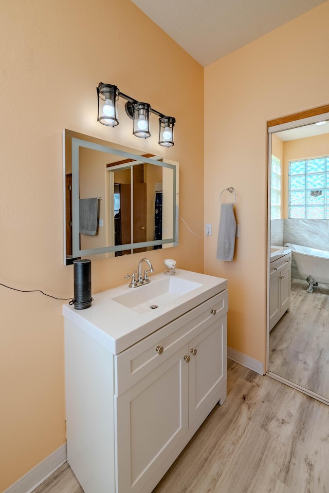 300 Thompson, Moriarty, NM 87035 - bathroom with vanity, wood finished floors, and a freestanding tub