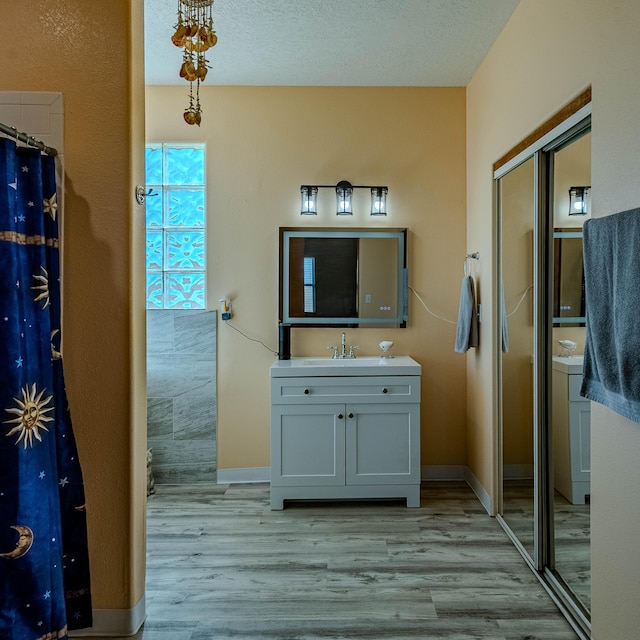 300 Thompson, Moriarty, NM 87035 - full bath with wood finished floors, vanity, and a shower with curtain
