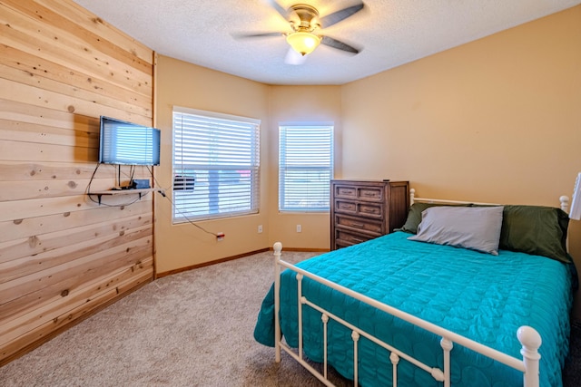 300 Thompson, Moriarty, NM 87035 - carpeted bedroom with a textured ceiling, ceiling fan, and wood walls