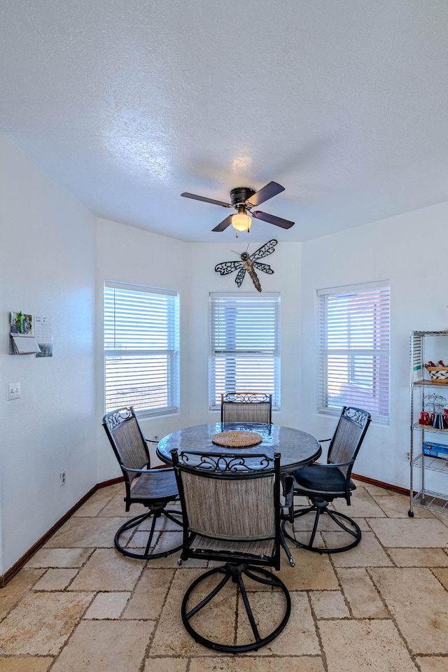 300 Thompson, Moriarty, NM 87035 - dining space with stone tile flooring, ceiling fan, and a textured ceiling