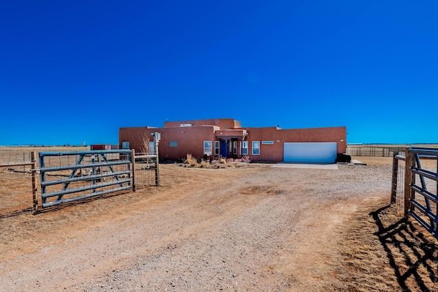 300 Thompson, Moriarty, NM 87035 - view of front of house with an attached garage, stucco siding, and driveway