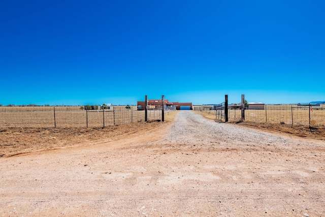 300 Thompson, Moriarty, NM 87035 - view of dirt / gravel road featuring a rural view and a gated entry