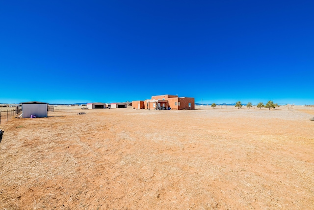 300 Thompson, Moriarty, NM 87035 - view of yard featuring an outbuilding and a view of countryside