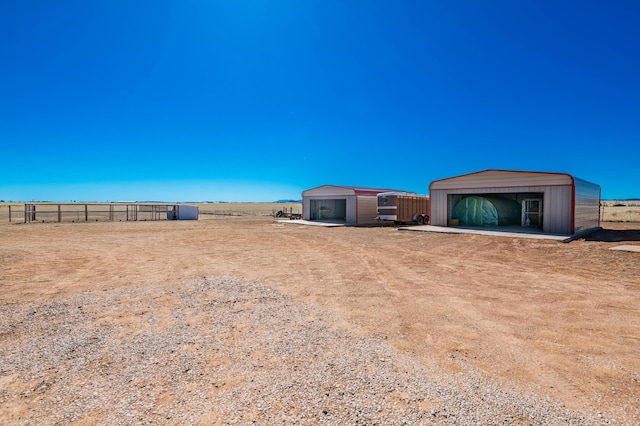 300 Thompson, Moriarty, NM 87035 - view of yard featuring a detached garage and an outbuilding
