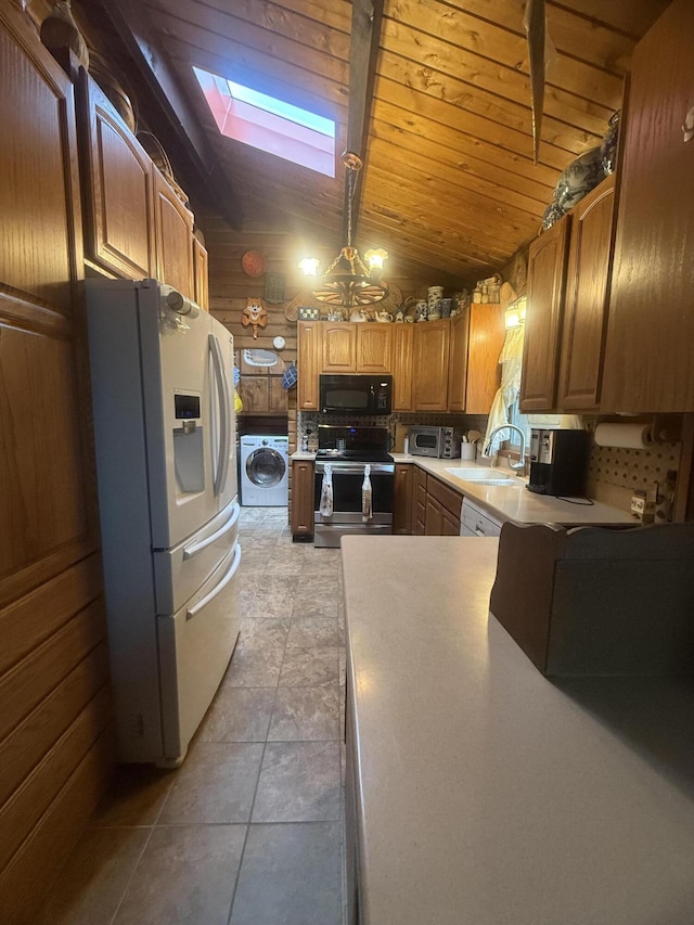 455 Obsidian Rd, Jemez Springs, NM 87025 - kitchen featuring washer / clothes dryer, electric range, white refrigerator with ice dispenser, black microwave, and a skylight