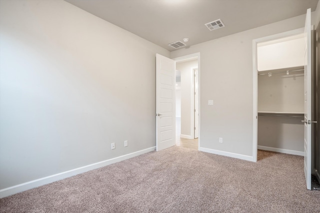 205 Silent Spring Dr NE, Rio Rancho, NM 87124 - unfurnished bedroom featuring carpet flooring, a spacious closet, and a closet