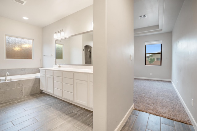 205 Silent Spring Dr NE, Rio Rancho, NM 87124 - full bathroom with a garden tub, vanity, and wood finished floors