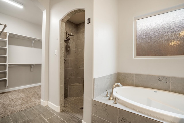 205 Silent Spring Dr NE, Rio Rancho, NM 87124 - full bath with a garden tub, a tile shower, a spacious closet, and wood finished floors