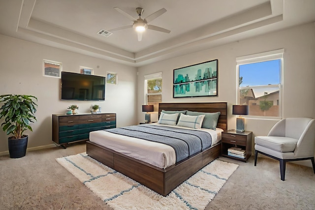 205 Silent Spring Dr NE, Rio Rancho, NM 87124 - carpeted bedroom featuring a tray ceiling and ceiling fan
