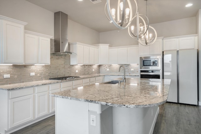 205 Silent Spring Dr NE, Rio Rancho, NM 87124 - kitchen featuring stainless steel appliances, wall chimney range hood, dark wood-style flooring, tasteful backsplash, and white cabinets