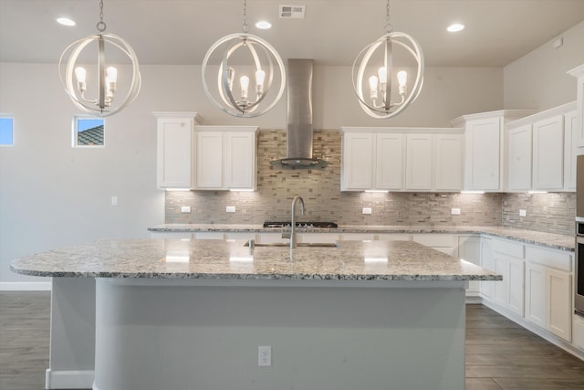 205 Silent Spring Dr NE, Rio Rancho, NM 87124 - kitchen featuring range hood, a chandelier, decorative backsplash, a kitchen island with sink, and recessed lighting