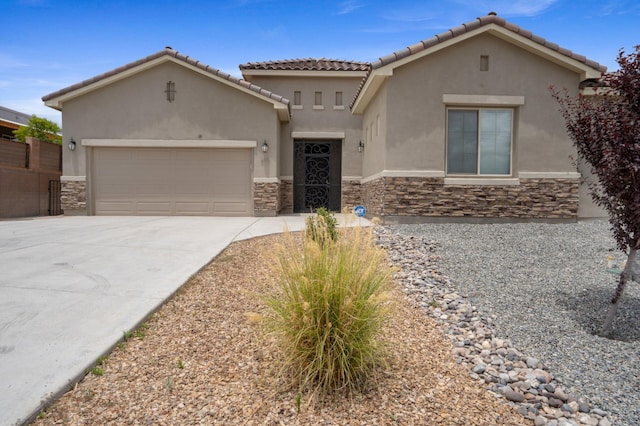 205 Silent Spring Dr NE, Rio Rancho, NM 87124 - mediterranean / spanish house with stone siding, concrete driveway, a garage, and stucco siding