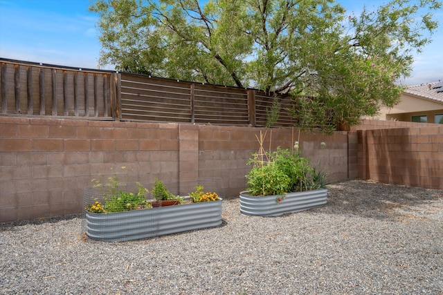 205 Silent Spring Dr NE, Rio Rancho, NM 87124 - fenced backyard featuring a vegetable garden