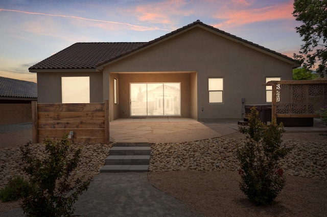 205 Silent Spring Dr NE, Rio Rancho, NM 87124 - view of front of home featuring stucco siding, a tile roof, and a patio area