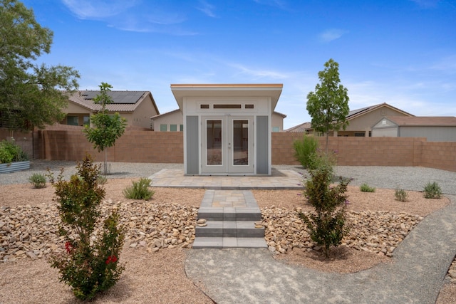 205 Silent Spring Dr NE, Rio Rancho, NM 87124 - view of front of home featuring french doors, a patio area, and a fenced backyard