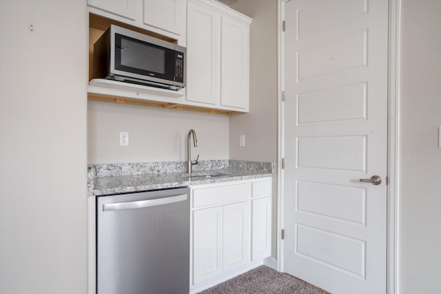 205 Silent Spring Dr NE, Rio Rancho, NM 87124 - kitchen with appliances with stainless steel finishes, white cabinets, carpet floors, and light stone countertops