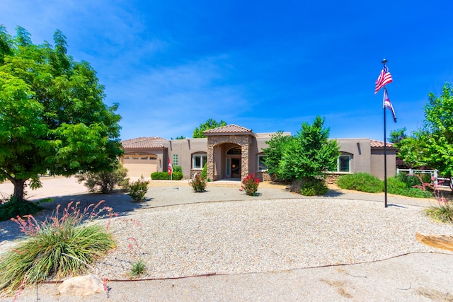 930 Titus Loop, Bosque Farms, NM 87068 - mediterranean / spanish-style home featuring stucco siding, a tiled roof, driveway, and an attached garage