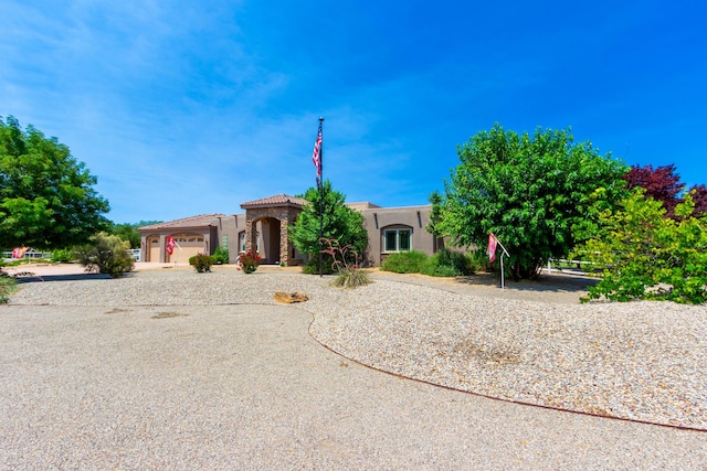 930 Titus Loop, Bosque Farms, NM 87068 - view of front of home featuring stucco siding, a garage, a tile roof, and concrete driveway