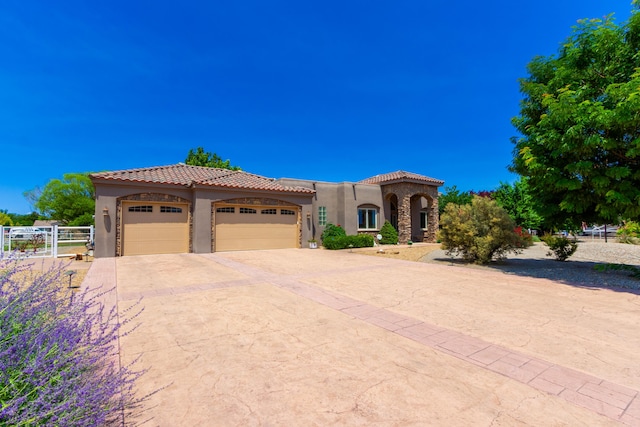 930 Titus Loop, Bosque Farms, NM 87068 - mediterranean / spanish home featuring an attached garage, stucco siding, a tile roof, and concrete driveway