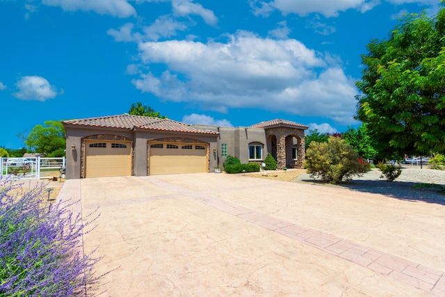 930 Titus Loop, Bosque Farms, NM 87068 - mediterranean / spanish-style home with stucco siding, a tiled roof, an attached garage, and driveway