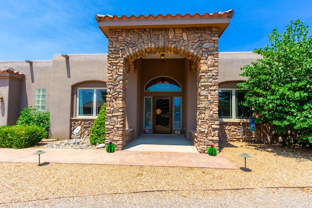 930 Titus Loop, Bosque Farms, NM 87068 - property entrance featuring stone siding and stucco siding