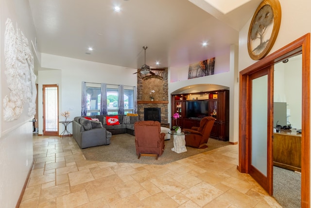 930 Titus Loop, Bosque Farms, NM 87068 - living area featuring stone tile flooring, a towering ceiling, ceiling fan, a stone fireplace, and recessed lighting