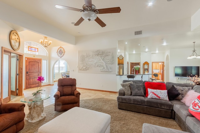 930 Titus Loop, Bosque Farms, NM 87068 - living area with a chandelier, arched walkways, a ceiling fan, and light tile patterned floors
