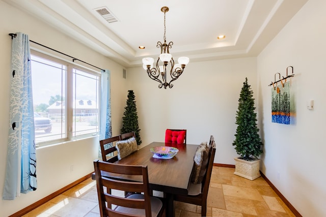 930 Titus Loop, Bosque Farms, NM 87068 - dining space with stone tile floors, a chandelier, a raised ceiling, and recessed lighting