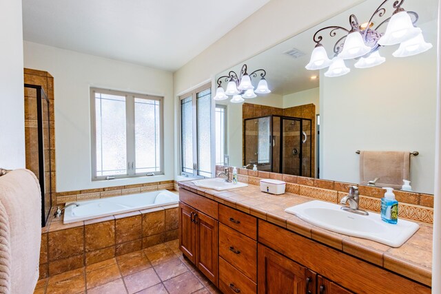 930 Titus Loop, Bosque Farms, NM 87068 - full bath featuring plenty of natural light, a chandelier, a shower stall, and a bath
