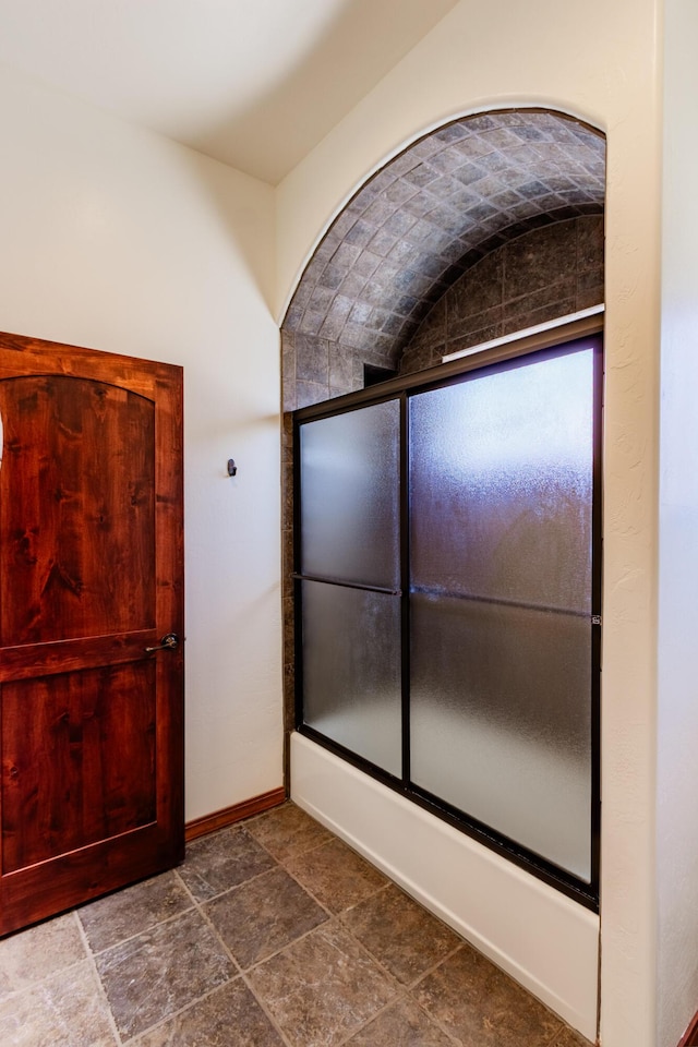 930 Titus Loop, Bosque Farms, NM 87068 - bathroom with stone finish floors and shower / bath combination with glass door