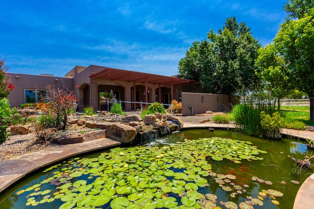 930 Titus Loop, Bosque Farms, NM 87068 - back of property with a small pond and stucco siding