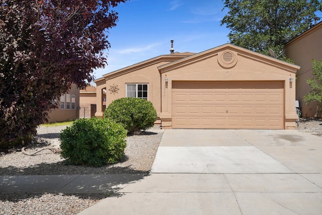 1944 Sierra Norte Loop NE, Rio Rancho, NM 87144 - view of front of property featuring stucco siding, a garage, and concrete driveway