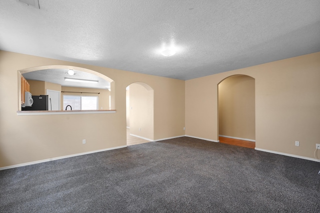 1944 Sierra Norte Loop NE, Rio Rancho, NM 87144 - carpeted spare room with a textured ceiling and arched walkways